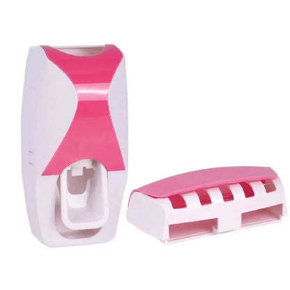 Automatic toothpaste dispenser with wall-mounted toothbrush holder in pink and white design for bathroom organization.